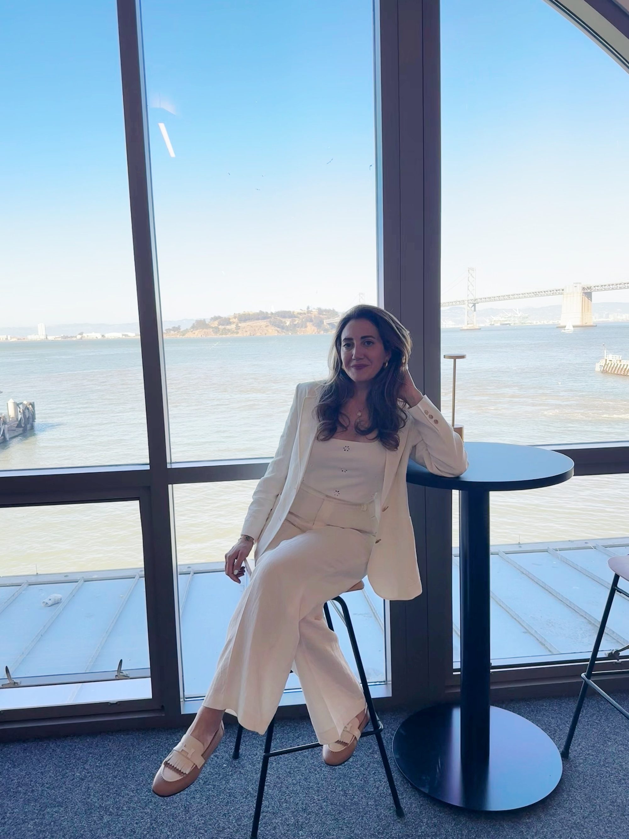 Yasaman Nazhand, integrative women's health practitioner, seated by a sunlit window